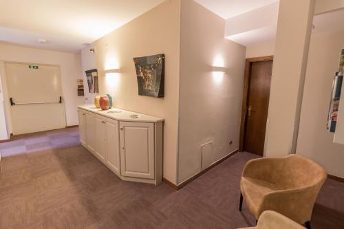 a living room with a chair and a table at Albergo Del Chianti in Greve in Chianti