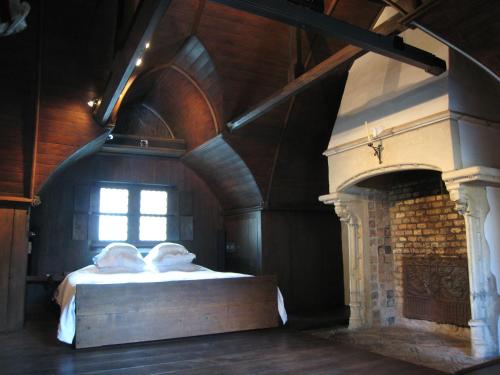 a bedroom with a bed and a fireplace at Guest House Nuit Blanche in Bruges