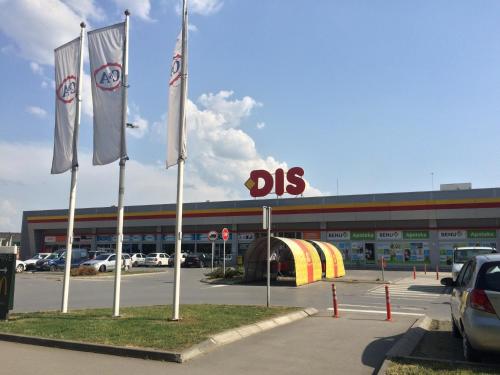 a dealership with flags in front of a building at Markoni in Pančevo