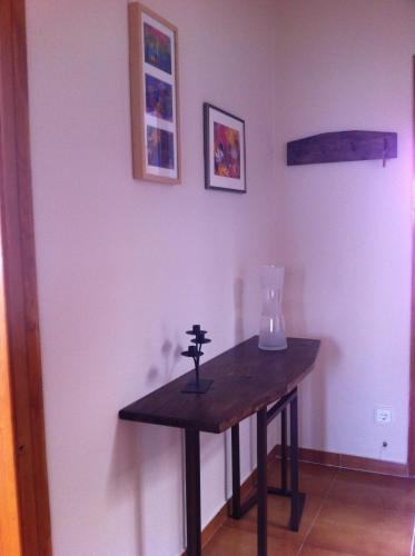 a wooden table in a room with a vase on the wall at Can Quilis in Pontós