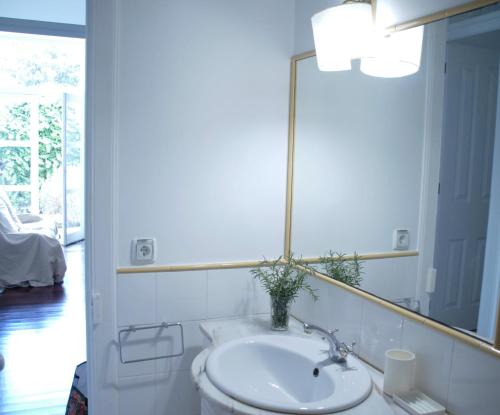une salle de bain avec un lavabo et un miroir dans l'établissement Pimenta Funchal Downtown, à Funchal