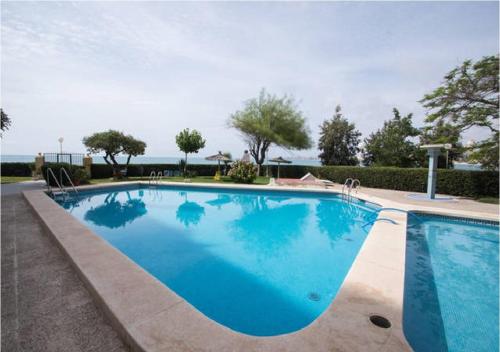 a large swimming pool with blue water at Apartamento Cabo Azul Playa Campello in El Campello
