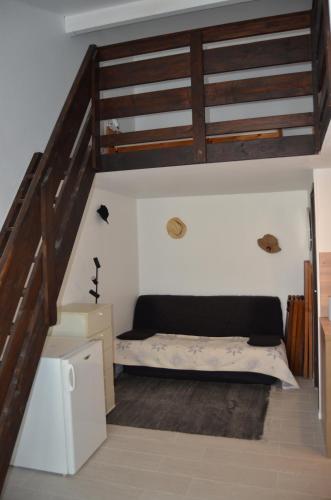 ルカートにあるMaisonnette La Franquiのベッドと階段のある部屋