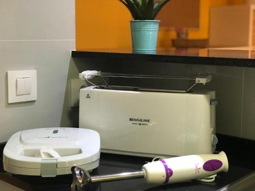 a machine on a counter with a roll of toilet paper at Lets Holidays RENOVATED APARTMENT NEAR BEACH in Tossa de Mar
