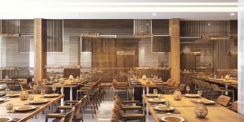 a dining room with wooden tables and chairs at Adora Hotel in Ho Chi Minh City