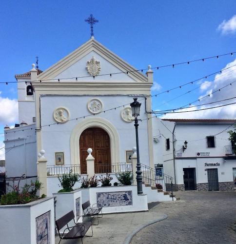 a church with a cross on the front of it at Casa las Torres B&B in Iznate