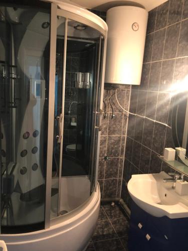 a bathroom with a shower and a toilet and a sink at Apartament Bella in Jurilovca