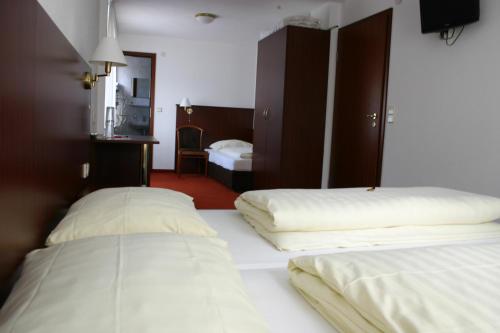 a hotel room with two beds and a mirror at Gasthaus Traube in Dettingen an der Erms