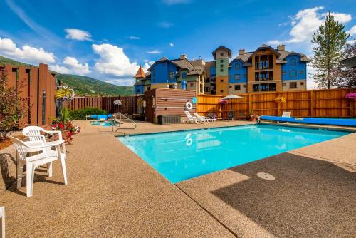 a swimming pool in front of a house at Snow Flower Condos in Steamboat Springs