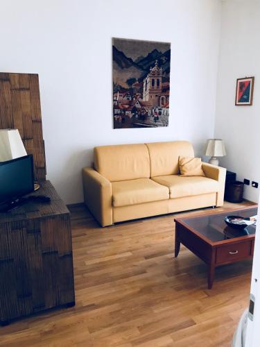 a living room with a couch and a coffee table at Sally's B&B in Carrara