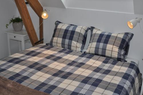 a bed with two pillows on top of it at Casa-Anja in Zingem
