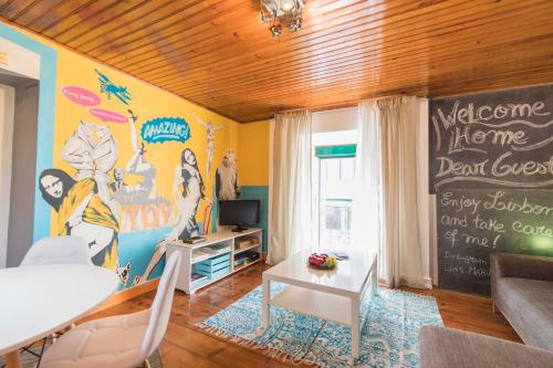 a living room with a painting on the wall at Picoas Artistic Flat in Lisbon