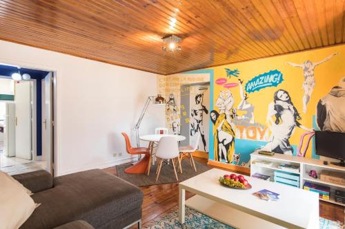 a living room with a couch and a table at Picoas Artistic Flat in Lisbon