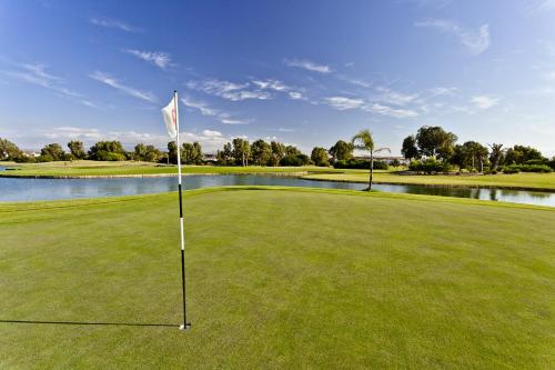 a golf course with a flag on the green at Appartement El Bahia Saidia destiné uniquement aux couple mariés, célibataires s'abstenir in Saidia 