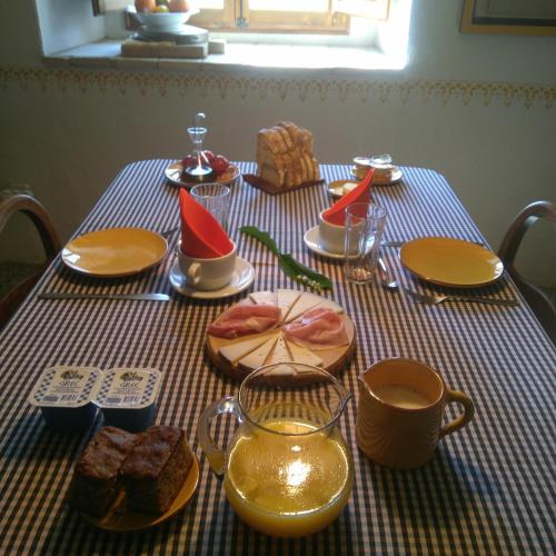 a table with plates of food on top at Mas Gibert in Sant Gregori