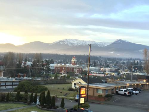 a view of a city with mountains in the background at Port Angeles Inn in Port Angeles