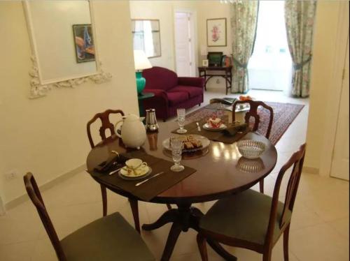 a dining room table and chairs in a living room at Casa di Ida in Locri