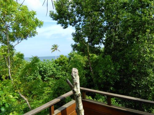 a view of a forest from a wooden fence at Cinnabar Resort in Tangalle