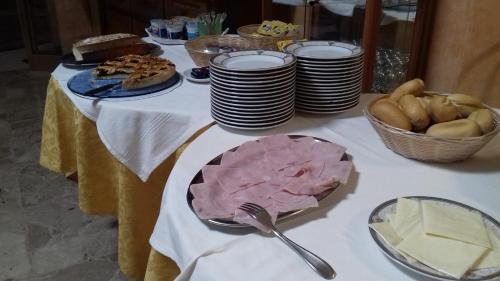 a table with plates of food and bread on it at Albergo La Primula in Chianciano Terme