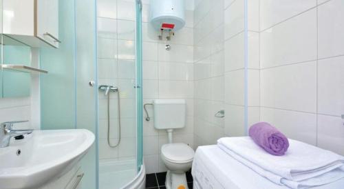 a bathroom with a sink and a toilet and a shower at Beautiful Apartment Jukic in Podstrana
