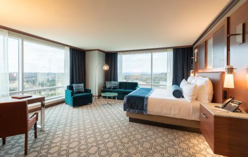 a hotel room with a bed and a desk at Resorts World Catskills in Monticello