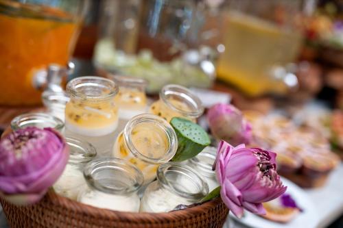 a basket filled with jars and flowers on a table at Adora Hotel in Ho Chi Minh City