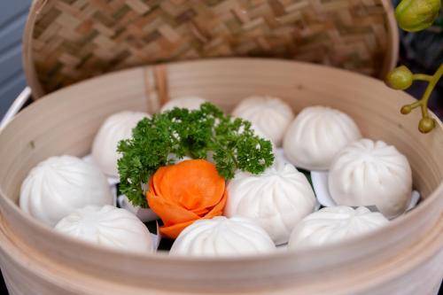 a basket with a bunch of onions and a carrot at Adora Hotel in Ho Chi Minh City