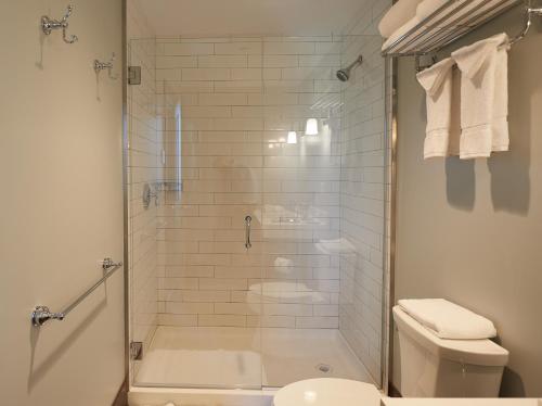 a bathroom with a shower and a toilet at The Groton Inn in Groton
