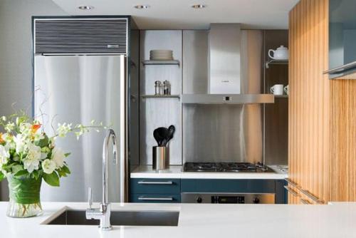 a kitchen with a refrigerator and a sink and a counter at L'Hermitage Hotel in Vancouver