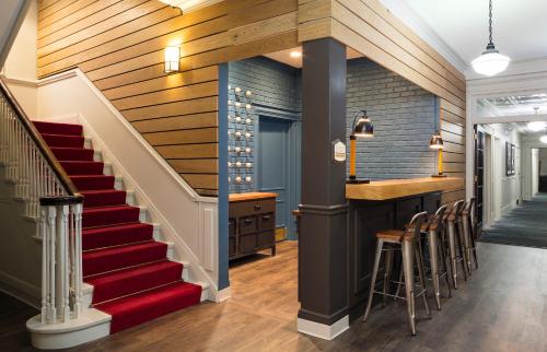 a staircase leading to a bar in a home with wooden walls at Majestic Hotel in Chicago