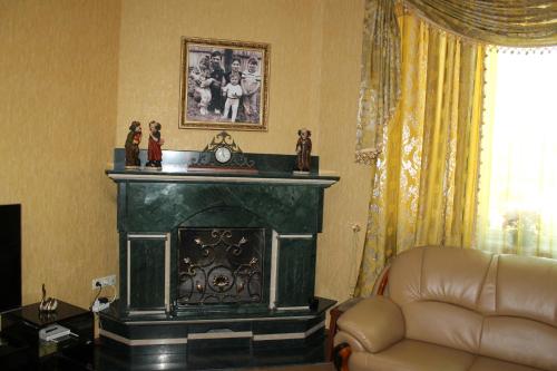 a living room with a fireplace and a couch at Green Guest House in Kutaisi