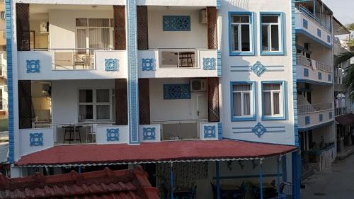an apartment building with blue and white paint at Delphin Hotel Side in Side