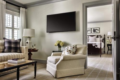 a living room with a couch and a chair at Inn at Perry Cabin in Saint Michaels