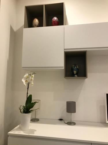 a white shelf with some vases and balls on it at A Matera "Sotto i pini" in Matera