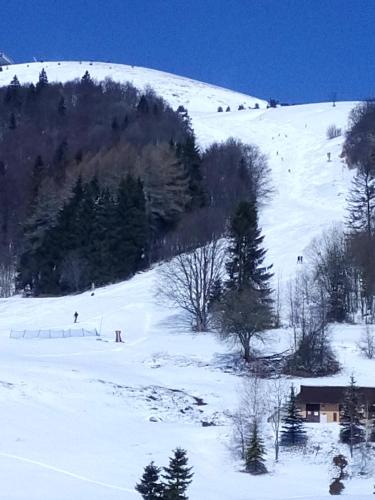a snow covered slope with people skiing down a hill at Apartment Dony in Donovaly