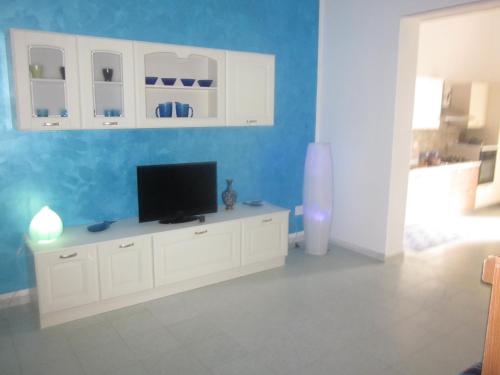 una sala de estar con TV en un armario blanco en Mondello Beach Holyday, en Palermo