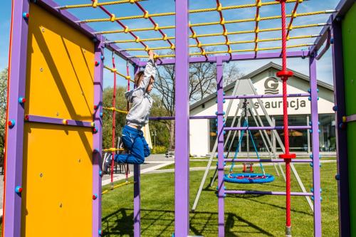 a child playing on a playground at Hotel Oskar Business & Spa in Puławy
