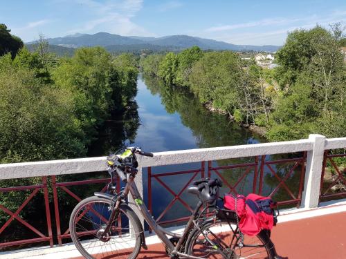 a bike parked on a bridge over a river at Paço da Torre de Figueiredo das Donas in Figueiredo das Donas