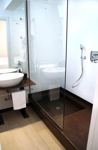 a bathroom with a glass shower and a sink at B&B a Ca' Minore Franciacorta in Passirano