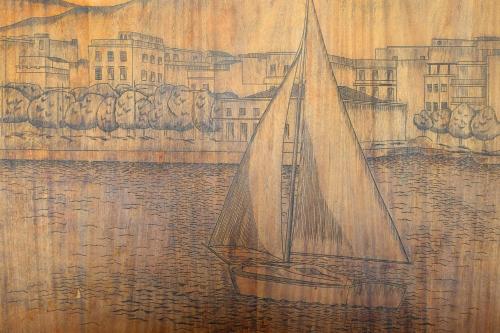a painting of a sail boat in the water at Hostal ROM Familiar in Roses