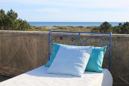 a blue and white pillow sitting on a balcony at Sea House in Viana do Castelo