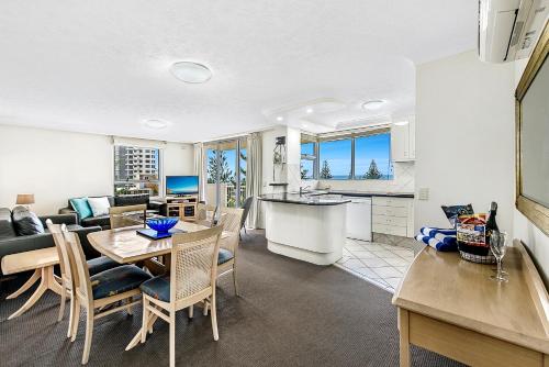 a kitchen and living room with a table and chairs at The Ritz Resort Heated Pool in Gold Coast