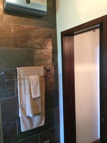 a bathroom with towels hanging on a wall at Casa dos Amigos - A luxury home in the nature in Torreira