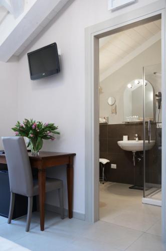 a dining room with a table and a sink at Hotel Giulio Cesare in Turin