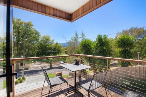 a view from the balcony of a house with a table and chairs at Brooklands Apartments in Healesville