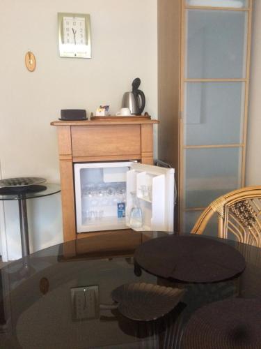 a small refrigerator in a room with a table at Breakwater Short Stay in Mandurah