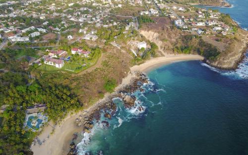 an aerial view of a beach and the ocean at Posada Real Puerto Escondido in Puerto Escondido