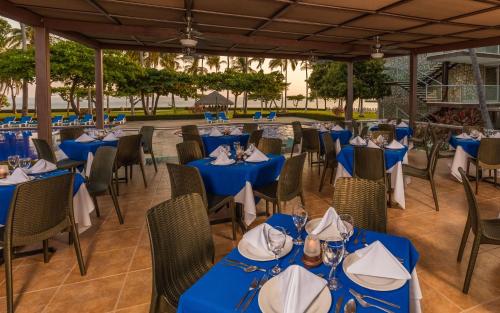 a group of tables and chairs with blue table cloths at Posada Real Puerto Escondido in Puerto Escondido