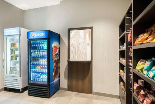 a grocery store with a soda machine in a room at Wingate by Wyndham Dieppe Moncton in Moncton