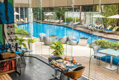 a view of the pool from the balcony of a hotel at Hotel Baraquda Heeton Pattaya by Compass Hospitality in Pattaya